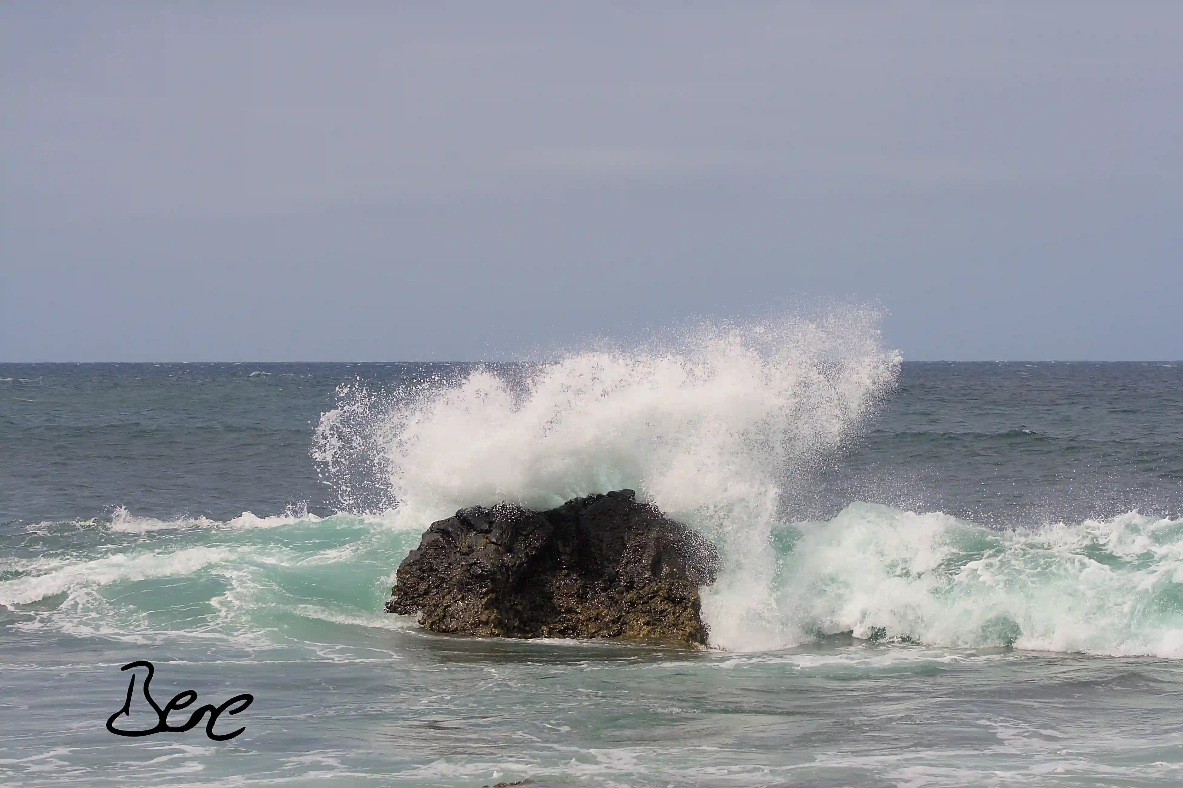 waves breaking at a stone